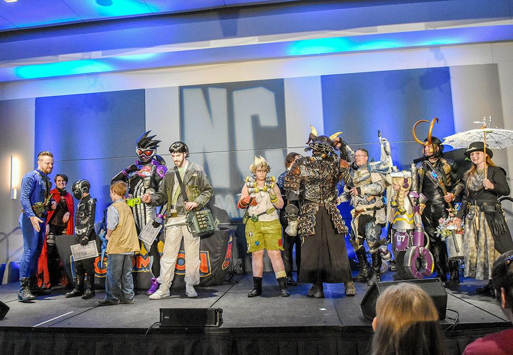 Winners of the Cosplay Showcase stand on stage together at NC Comicon on Sunday in the Raleigh Convention Center. NC Comicon was a two-day weekend event that hosted exhibits, panels and special guests in an inclusive comic book pop culture experience.