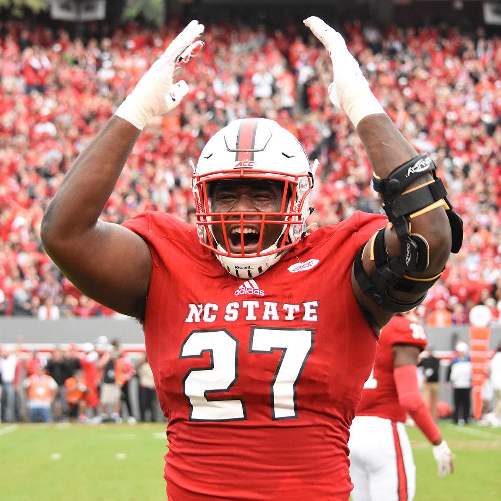 Senior defensive tackle Justin Jones hypes up the crowd in between plays at the Homecoming game against Clemson in Carter-Finley Stadium, Saturday, Nov. 4. The Wolfpack lost the Homecoming game against Clemson, 31-38.