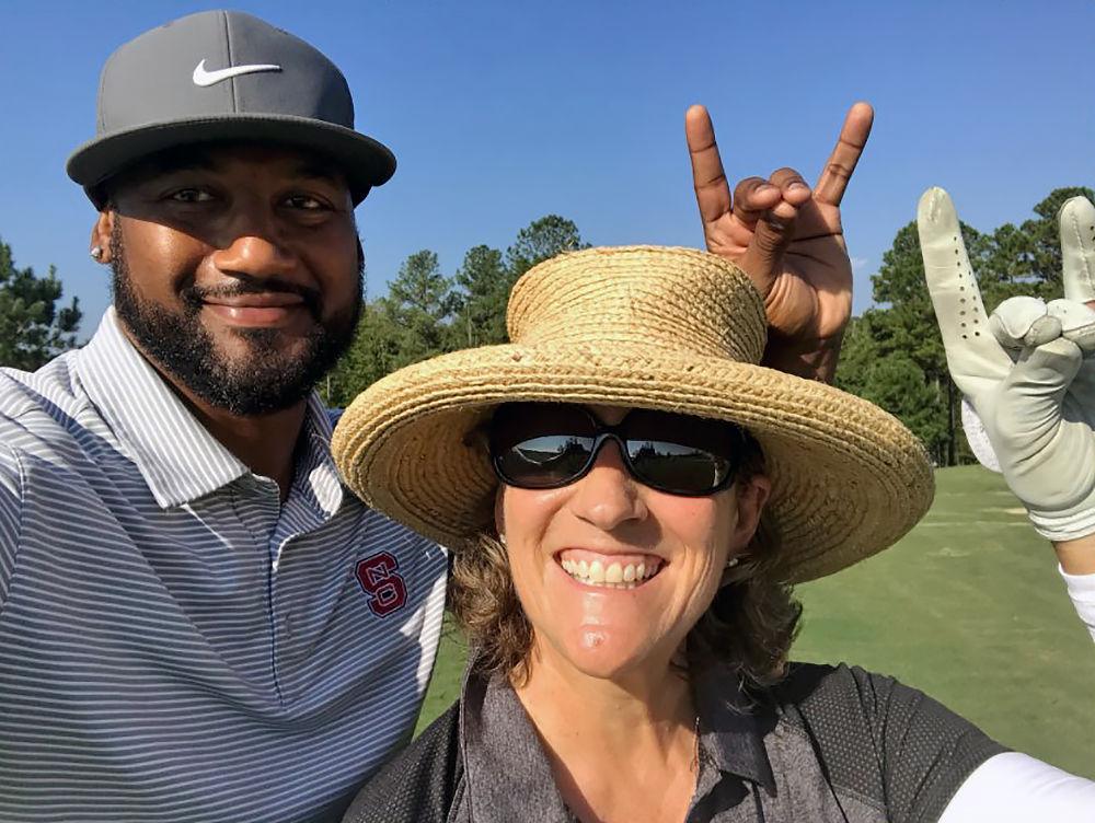 Women's golf head coach Page Marsh poses for a photo with football alumnus Koren Robinson at the 2017 Legends Tournament at Lonnie Poole Golf Course on Sept. 22.