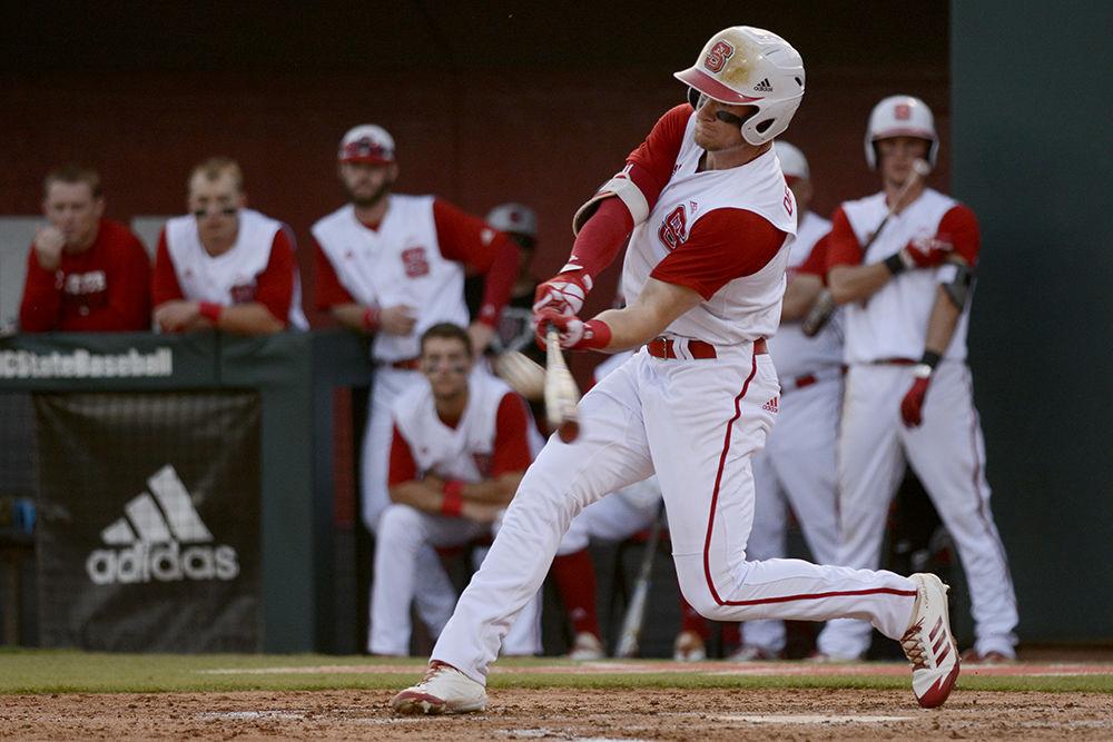 Senior outfielder Brock Deatherage hits a home run against Notre Dame on Friday. The Wolfpack lost the opening game of the series 12-8.