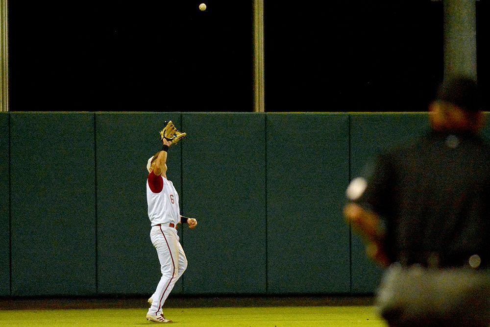 Junior outfielder Brett Kinneman catches a fly ball against Auburn at Doak Field on Sunday. Kinneman went 0-4 with two strikeouts and one run scored as the Wolfpack lost 15-7.