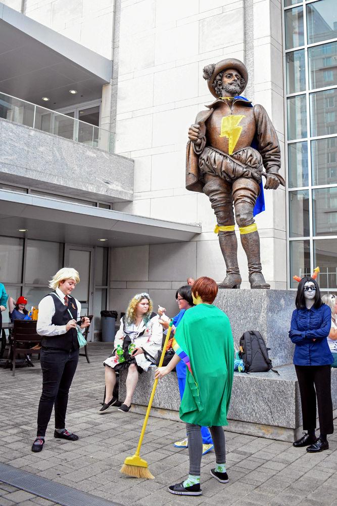 Guests of Raleigh Supercon stand around the Sir Walter Raleigh statue outside of the Raleigh Convention Center on Saturday, July 28, 2018. Sir Walter Raleigh was decorated to look like Shazam, or Captain Marvel, a DC Comic superhero. Raleigh Supercon is an annual 3-day event that celebrate comics, cosplay, anime, cartoons, video games, and all things pop culture by allowing guests to meet celebrities, attend panels, and browse vendors.