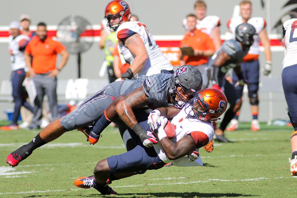 Junior defensive end Darian Roseboro makes a big hit during the 33-25 win over Syracuse on Saturday in Carter-Finley Stadium.