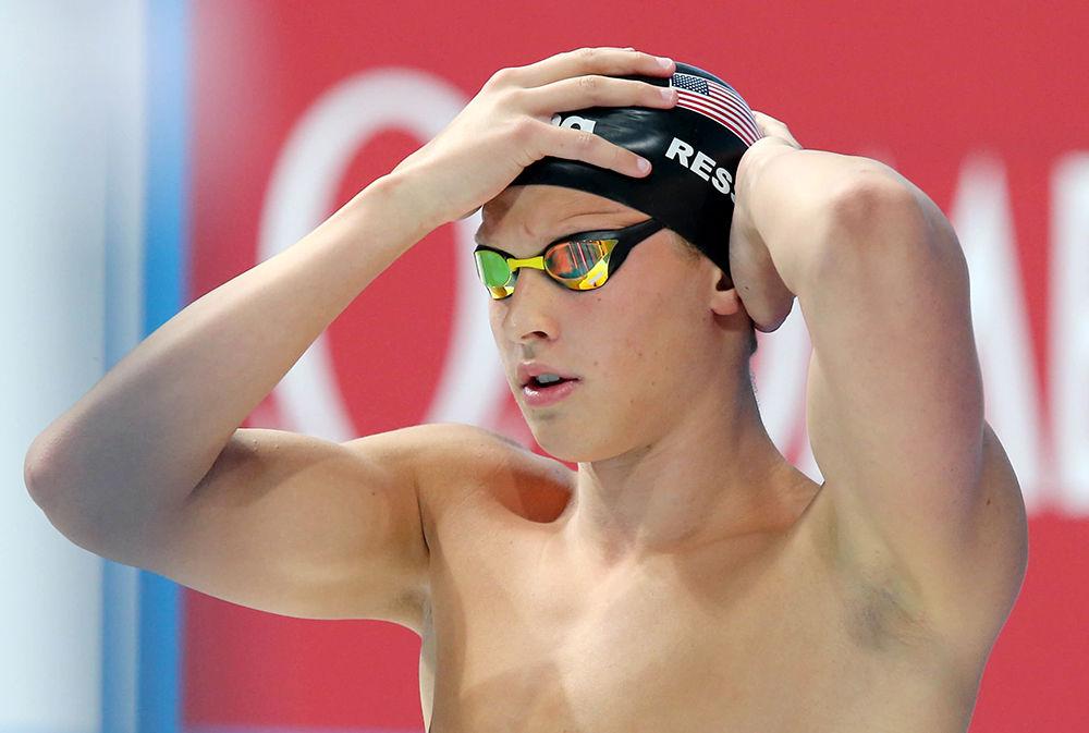 Senior Justin Ress adjusts his swim cap before an event. Ress studies applied math and hails from Cary.&#160;&#160;