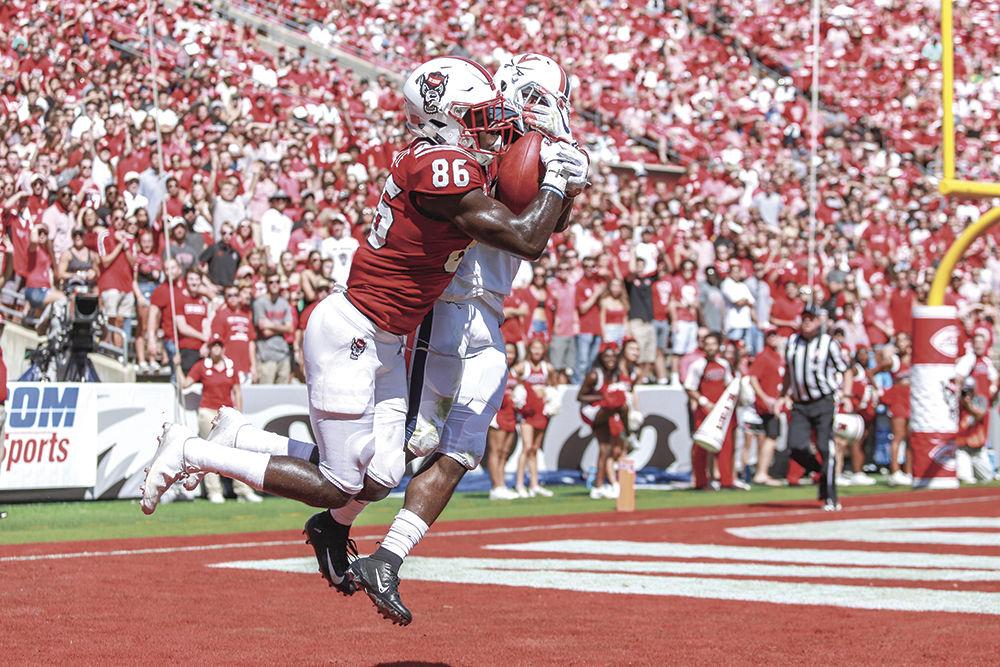 Sophomore wide receiver Emeka Emezie is contested, but brings the ball down for a touchdown for the Pack to take the lead. Emezie had five receptions for 90 yards during the 35-21 win over Virginia on Saturday, Sept. 29 at Carter-Finley Stadium.