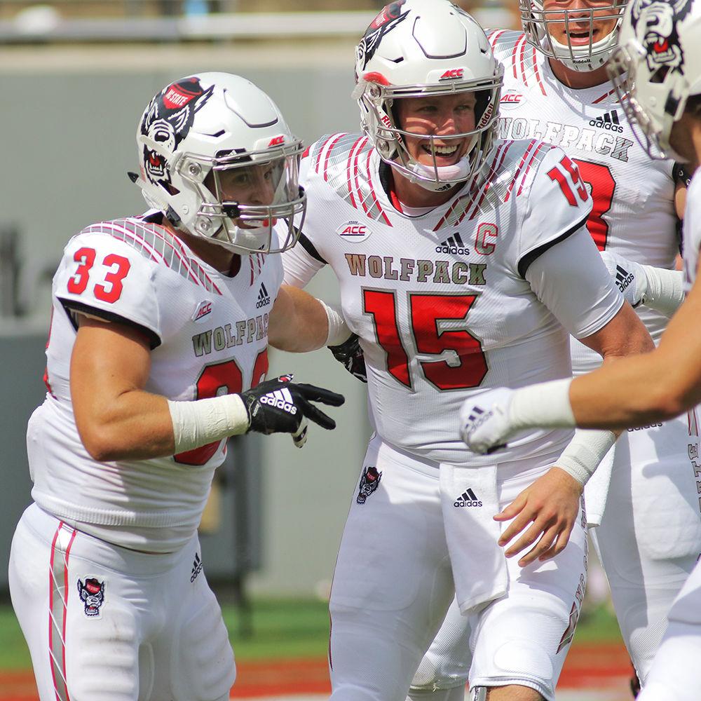 Graduate quarterback Ryan Finley celebrates with graduate running back Brady Bodine after he scored a 39-yard touchdown during the 41-7 win over Georgia State on Saturday, Sept. 8 in Carter-Finley Stadium.