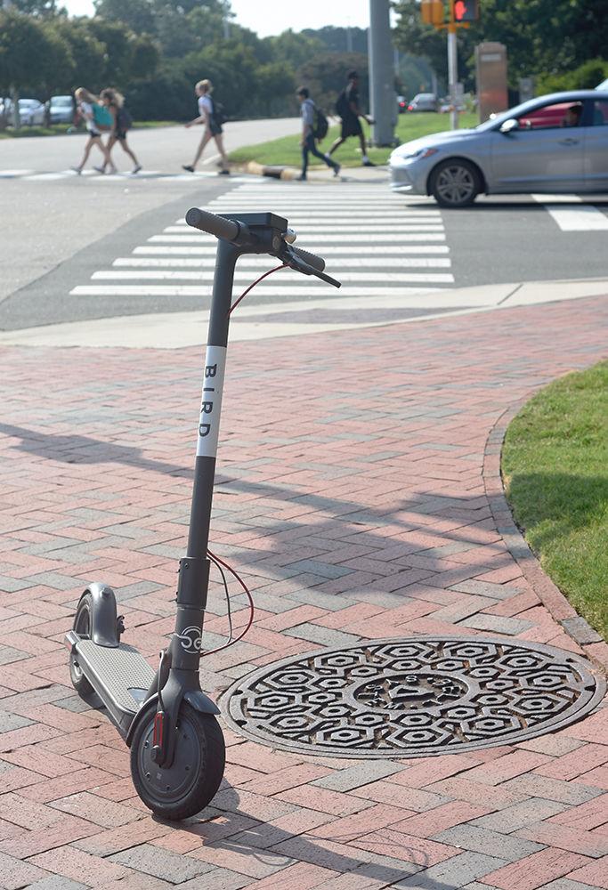 A Bird scooter is seen parked near a crosswalk at the corner of Morrill Drive and Western Boulevard on Tuesday, Aug. 28, 2018. The electrically-powered scooters are part of a vehicle sharing program which has recently been established in Raleigh. Some Bird scooters can be seen around NC State's campus.