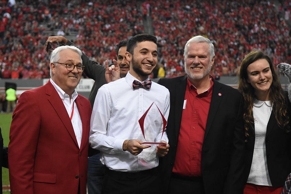 Victor Eduardo, a third-year studying philosophy, is awarded the 2017-2018 Leader of the Pack award during the Homecoming game against Clemson in Carter-Finley Stadium, Saturday, Nov. 4. The Leader of the Pack award recognizes students who make outstanding contributions to NC State in the areas of leadership, scholarship and community service. The Wolfpack lost the Homecoming game against Clemson, 31-38.
