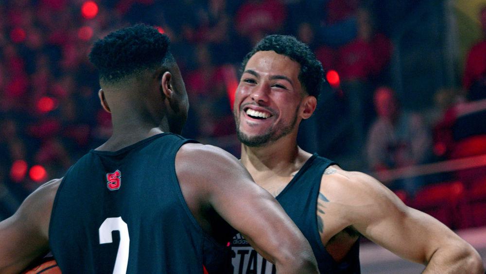 Redshirt senior guard Torin Dorn and redshirt sophomore guard Devon Daniels bump chests at Primetime with the Pack on Friday, Oct. 19 in Reynolds Coliseum.