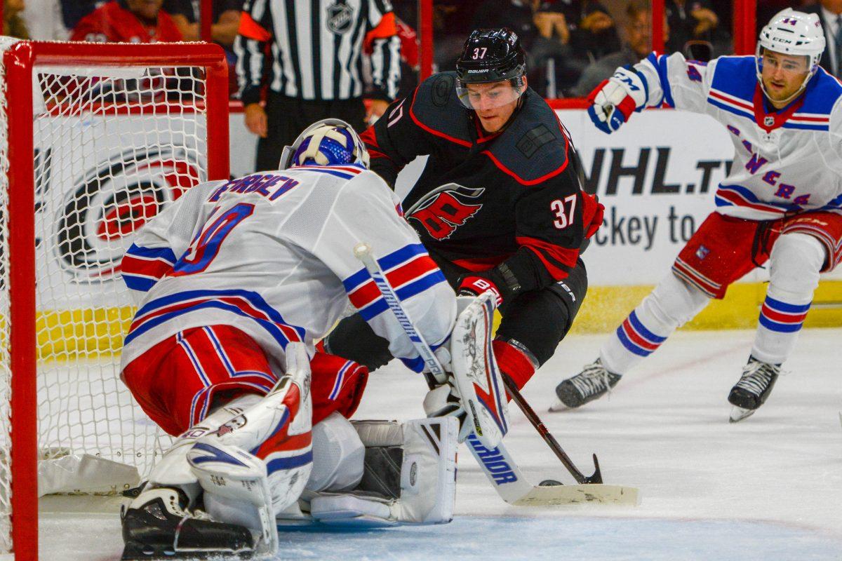 Carolina Hurricanes forward Andrei Svechnikov battles with New York Rangers goaltender Alexandar Georgiev on Sunday, Oct. 7 in PNC Arena. Svechnikov scored his first NHL goal against the Rangers and contributed to the Hurricanes' 8-5 win.