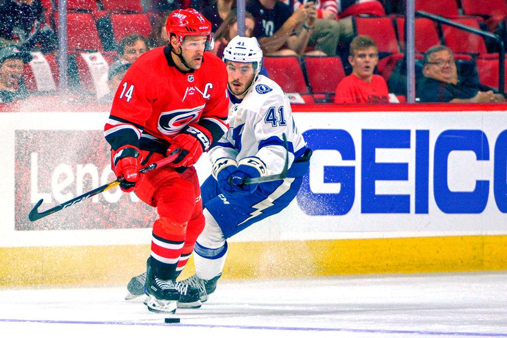 Carolina Hurricanes captain and forward Justin Williams looks to pass the puck against the Tampa Bay Lightning on Wednesday, Sept. 19 in PNC Arena. Williams had 3 assists and 1 shot on goal as the Hurricanes beat the Lightning 6-1.