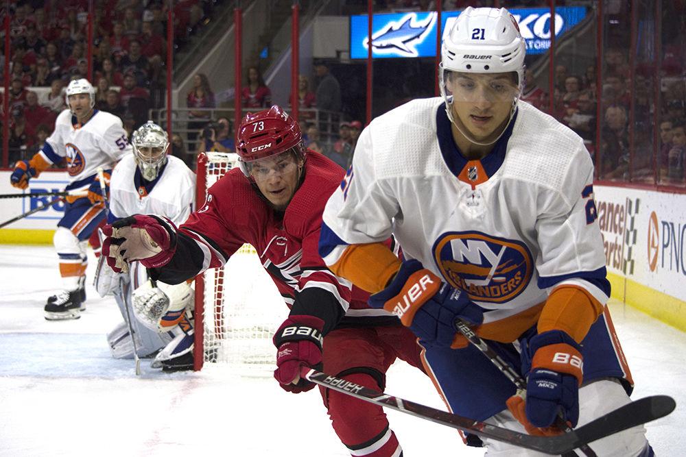 Carolina Hurricanes left wing Valentin Zykov pressures New York Islanders defenseman Luca Sbisa on Thursday, Oct. 4 at PNC Arena. Zykov had 3 shots on goal as the Hurricanes lost to the New York Islanders 2-1 in overtime.