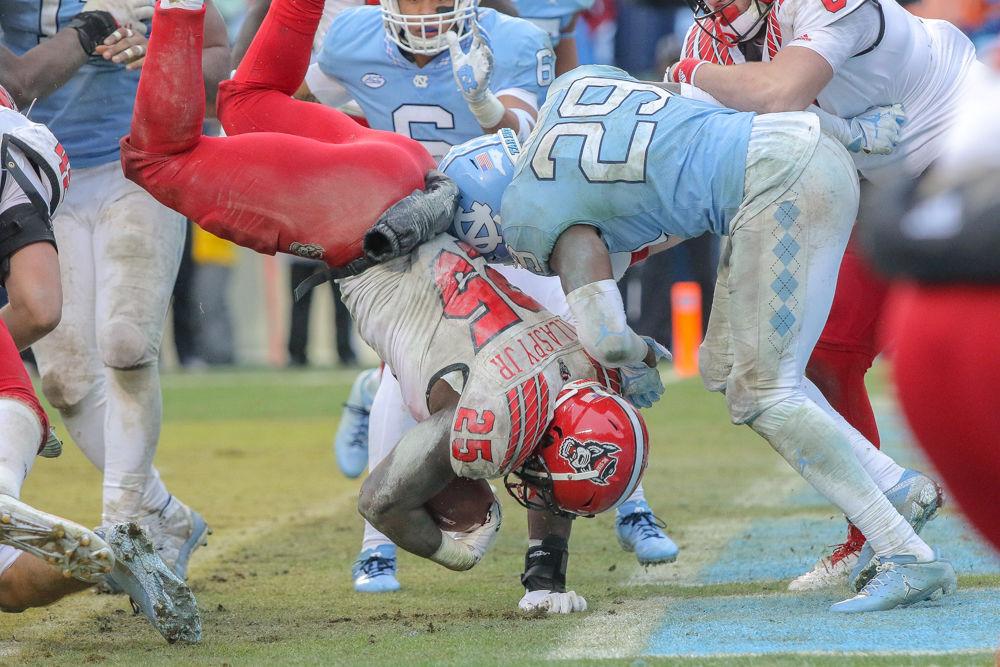 Senior running back Reggie Gallaspy Jr. lands in the end zone for the game-winning touchdown to give the Pack the 34-28 overtime win in Kenan Memorial Stadium on Saturday, Nov. 24. Gallaspy had a career high 129 yards.