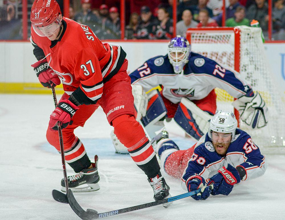 Carolina Hurricanes forward Andrei Svechnikov gets the puck knocked loose by Columbus Blue Jackets defenseman David Savard on Saturday, Nov. 17 in PNC Arena. The Hurricanes lost to Columbus 4-1.