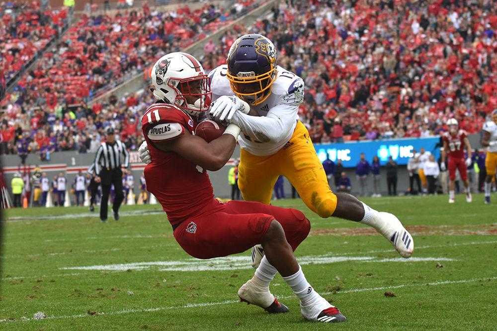 Redshirt junior wide receiver Jakobi Meyers maintains possession of the ball while being tackled by East Carolina defensive back Davondre Robinson on Saturday, Dec. 1 at Carter-Finley Stadium. Meyers broke the NC State record for single-season receptions during the game, totaling 89 on the year. The Wolfpack won 58-3 in a game that was a shutout until the last three seconds of regulation time.&#160;