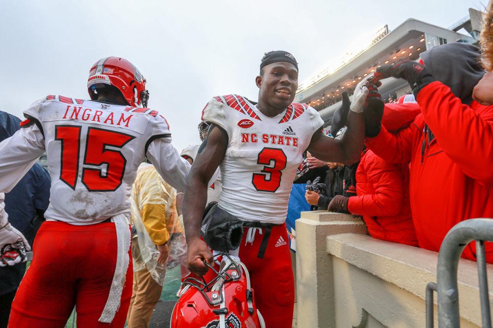 Junior wide receiver Kelvin Harmon fives fans on the way back to the locker room. The Wolfpack was tested by the Tar Heels, but came away with a 34-28 overtime win on Saturday, Nov. 24 in Kenan Memorial Stadium.
