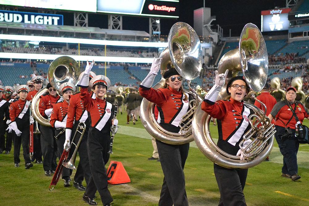 The NC State marching band holds up wolfies as they walk past the stands during the Gator Bowl against Texas A&amp;M on Monday, Dec. 31 in the TIAA Bank Field in Jacksonville, Florida. The Wolfpack lost to the Aggies 52-13, ending their season with a 9-4 record.