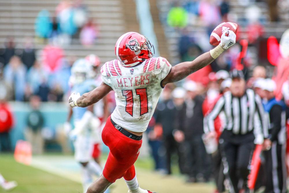 <p>Redshirt junior wide receiver Jakobi Meyers makes an acrobatic catch on the sidelines during the game against UNC in Kenan Memorial Stadium on Saturday, Nov. 24, 2018. Meyers had 111 yards on seven receptions. </p>