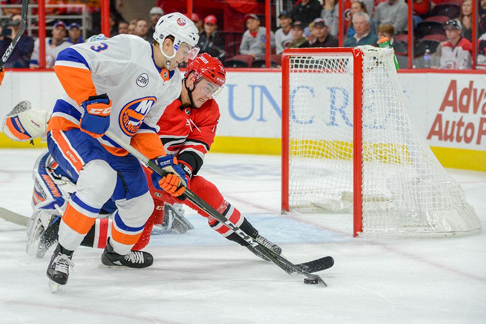Carolina Hurricanes foward Micheal Ferland battles for the puck against the New York Islander defense on Sunday, Oct 28 in PNC Arena. The Hurricanes lost to the Islanders 2-1.