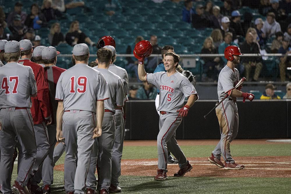 Sophomore centerfielder Patrick Bailey scores the game-winning run at the top of the eleventh inning against Coastal Carolina University, Sunday, Feb. 24. The Pack won 7-6 and continue to be undefeated thus far in the season.