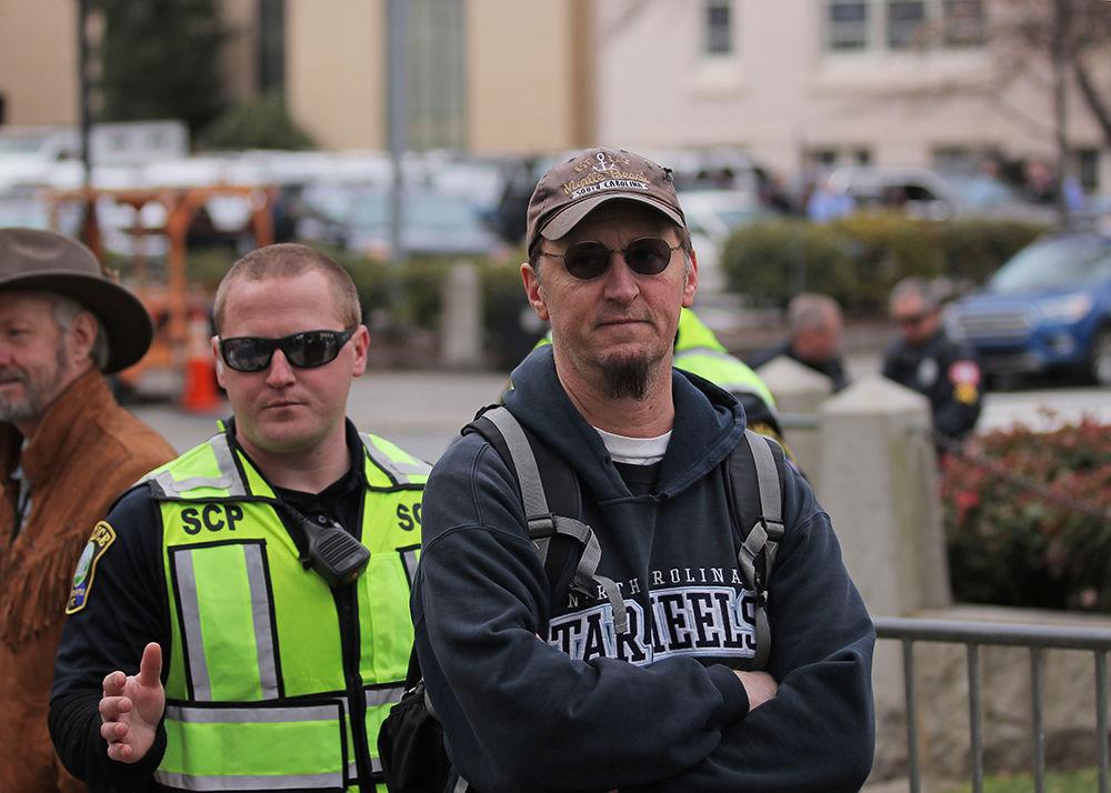 Micheal, a protester is, escorted away by a police officer after a confrontation at the Crush Confederates at the Capital event on Saturday, Feb. 9 at the North Carolina State Capitol in Raleigh.