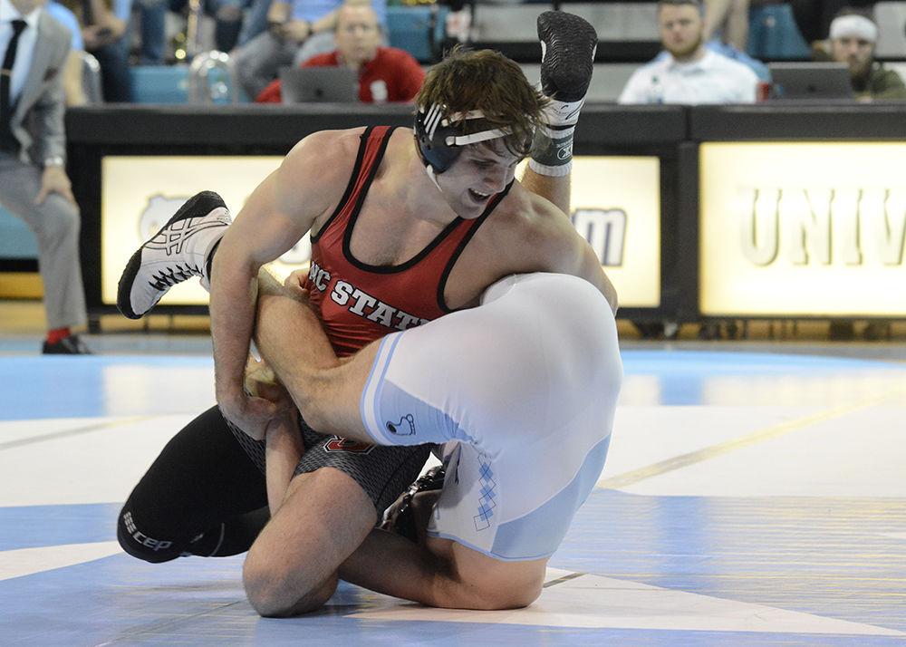Editor's note: the original photo has been replaced.
Nick Reenan, a redshirt sophomore in the 184-pound weight class, wrestles with his opponent during the dual against UNC-Chapel Hill on Friday, Feb. 15, in Carmichael Arena. The Wolfpack beat the Tarheels 20-14.