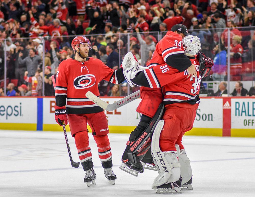 Carolina Hurricanes goalies Petr Mrazek and Curtis McElhinney celebrate with defenseman Jaccob Slavin after the Hurricanes beat the Montreal Canadiens in overtime on Sunday, March 24, 2019 in PNC Arena. The Hurricanes beat the Canadiens 2-1.