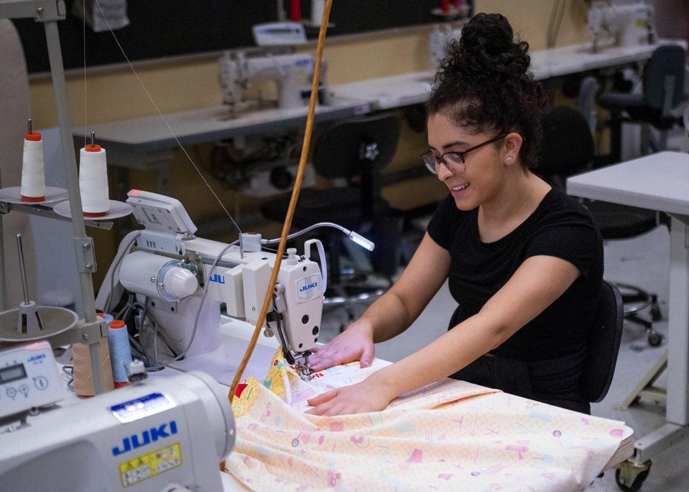 Victoria Gerson, a graduate student in graphic design, stitches a pillowcase for the Pillowcase Project during Service Raleigh on Saturday, April 13, at the Wilson College of Textiles. Service Raleigh aims to provide volunteers from NC State and surrounding communities to local organizations which require them.