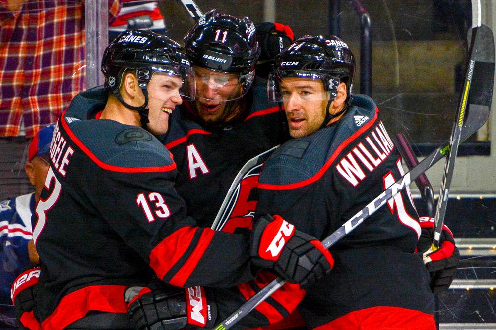 Carolina Hurricanes forwards Jordan Staal, Justin Williams and Warren Foegele celebrate a goal from Staal against the New York Rangers on Sunday, Oct. 7, 2018 in PNC Arena. The Canes beat the Rangers 8-5.