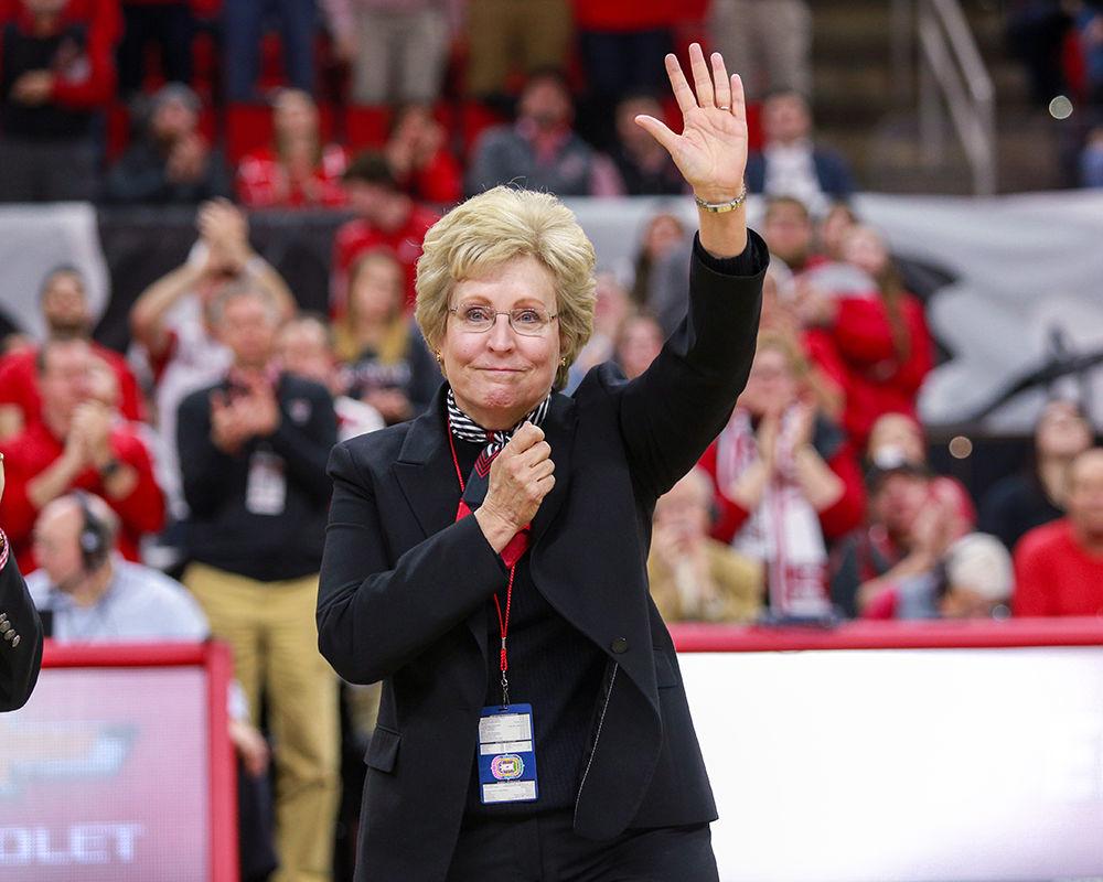 Director of Athletics Debbie Yow taps on her heart and waves to fans before throwing up a wolfie after being recognized at senior night, the last home game she will attend as director of athletics. The men&#8217;s basketball team was unable to pull off a come-from-behind win, falling 63-61 to Georgia Tech on, March 6 in PNC Arena.
