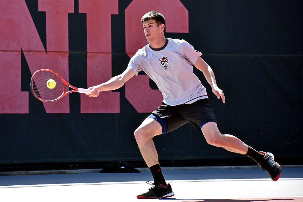 Senior Igor Saveljic returns a volley against Louisville senior Brandon Lancaster on Sunday, March 17, 2019 in J.W. Isenhour Tennis Center. Saveljic won the first set 6-5 and the second set 5-3. The Wolfpack defeated Louisville 4-1.