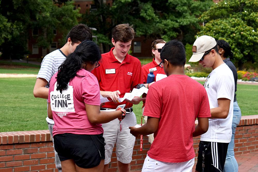 Peer mentor, Mitchell Moravec, helps Summer Start participants navigate through campus using an NC State campus map. Moravec was one of the many peer mentors who gave a tour to students during the Wolfpack Wondering event on Sunday, June 25, 2018. The event allowed students to see the buildings that their classes were going to be held in during summer session II.