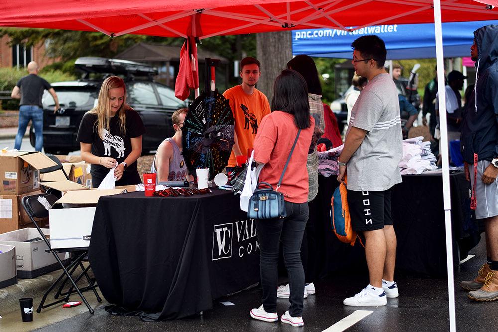 Packapalooza attendees spin a prize wheel at the Valentine Commons tent on Saturday, August 24, 2019. The wheel featured an opportunity to win a tank top advertising the student housing facility.