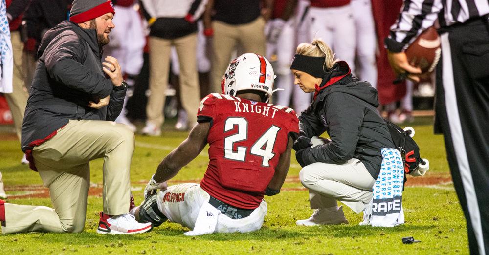 Freshman running back Zonovan Knight holds his leg after getting injured during a rush on Saturday, Nov. 9, 2019 at Carter Finley Stadium.