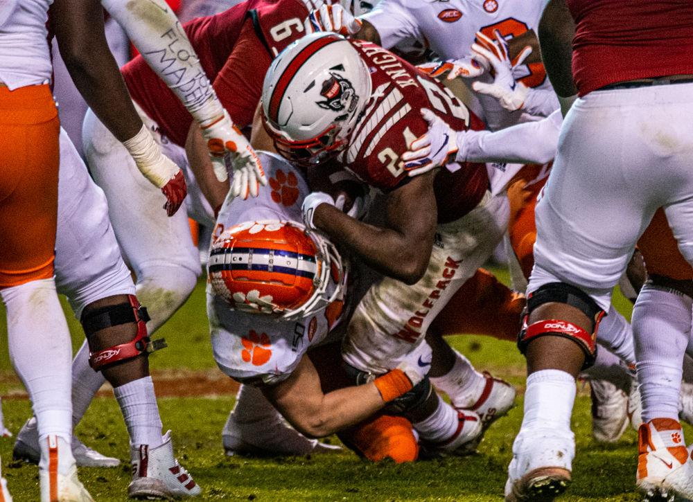 Freshman running back Zonovan Knight is tackled during a rush on Saturday, Nov. 9, 2019 at Carter Finley Stadium.