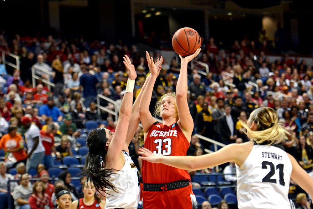 Freshman center Elissa Cunane shoots against Iowa forward/center Megan Gustafson and forward Hannah Stewart on Saturday, March 30 at Greensboro Coliseum. Cunane recorded a double-double, scoring 14 points and grabbing 11 rebounds in the Wolfpack&#8217;s 79-61 loss to the Hawkeyes.