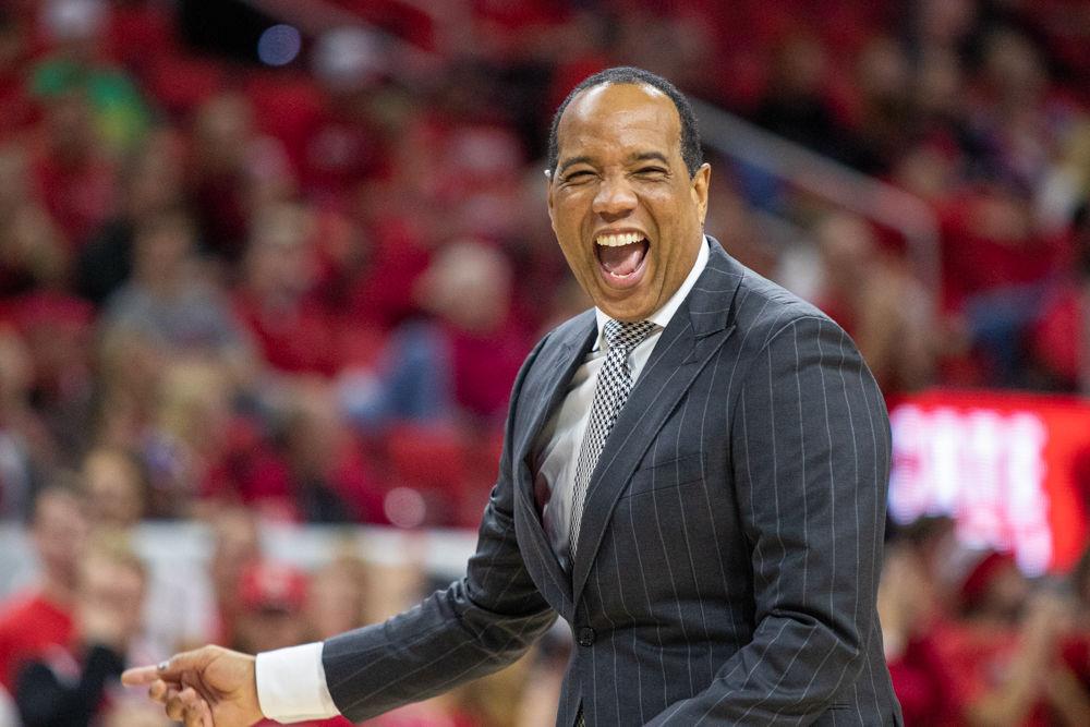 Coach Kevin Keatts laughs with a fan after a out of bounds call versus Little Rock on Saturday, Nov. 23, 2019 at PNC Arena. The Wolfpack won 74-58