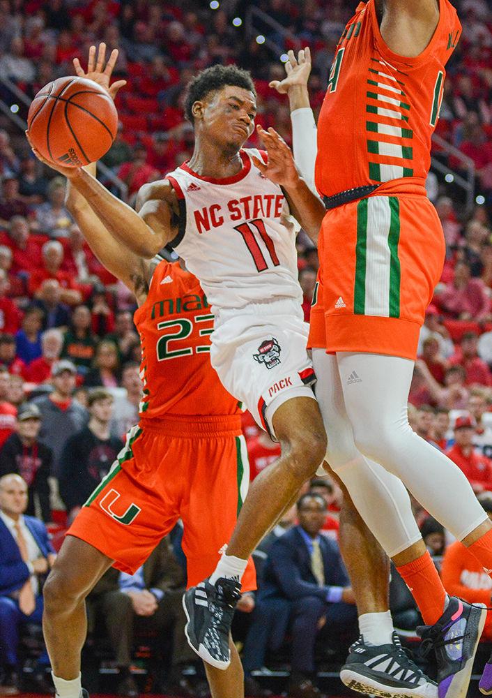 Senior guard Markell Johnson goes for a wraparound pass to save the ball during the game versus Miami on Wednesday, Jan. 15, 2020 in PNC Arena. Johnson scored 10 points and had 4 steals against Miami. The Wolfpack beat the Hurricanes 80-63.