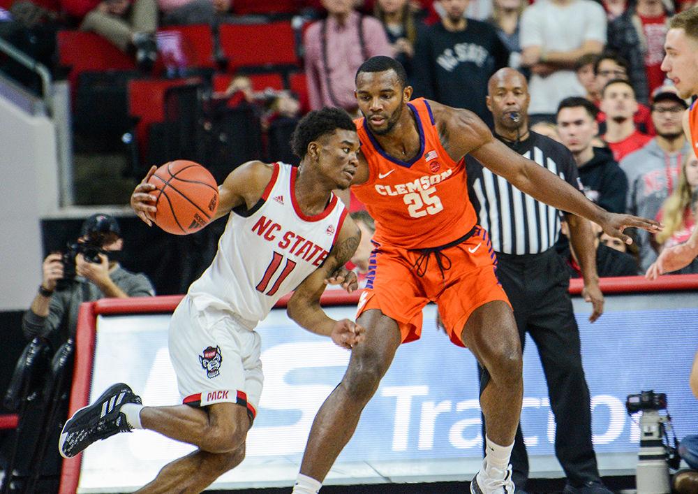 Senior guard Markell Johnson dribbles the ball past two Clemson players during the Men's Basketball game at the PNC Arena on Saturday, Jan. 18, 2020. The Wolfpack beat the Tigers 60-54, with Johnson scoring 13 points.