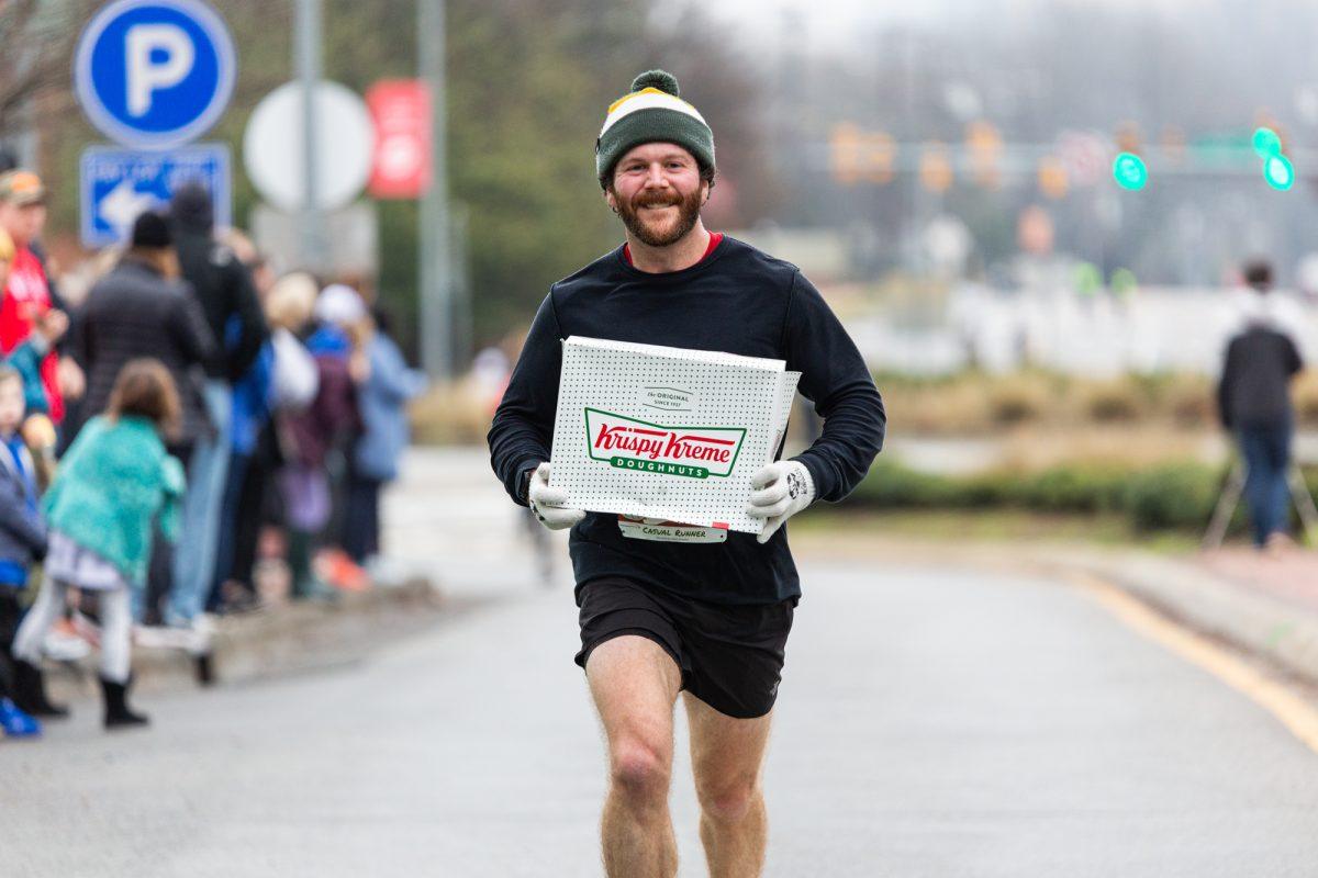 Joseph Silvers, from Raleigh, finishes with a time of 32 minutes and 49 seconds during the Krispy Kreme Challenge, Saturday, Feb. 1, 2020 at the Memorial Bell tower.