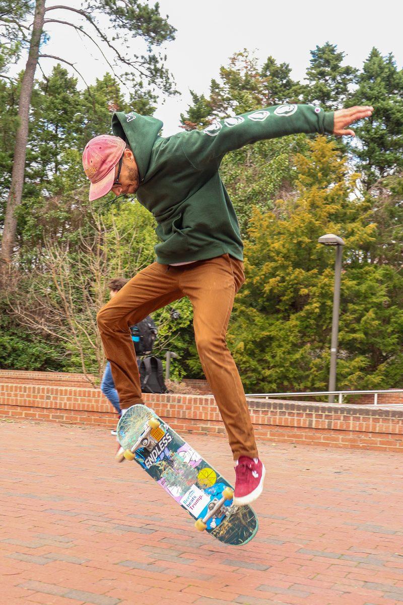 Michael Miracco, a fourth-year majoring in psychology, kickflips with his skateboard in Wolf Plaza on Friday, Feb. 7, 2020. The Wolf Plaza is known for people skateboarding and doing tricks, and many NCSU students skateboard to class or for leisure.