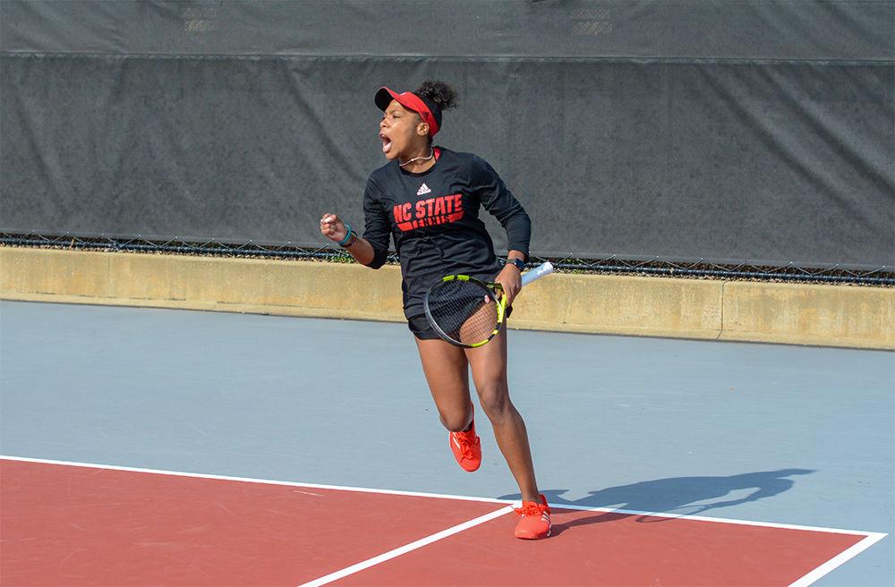 Junior Jaeda Daniel exclaims after her doubles team won a point during the match against Wake Forest at the J.W. Isenhour Tennis Center on Friday, Feb. 28, 2020. The Wolfpack won 5-2.