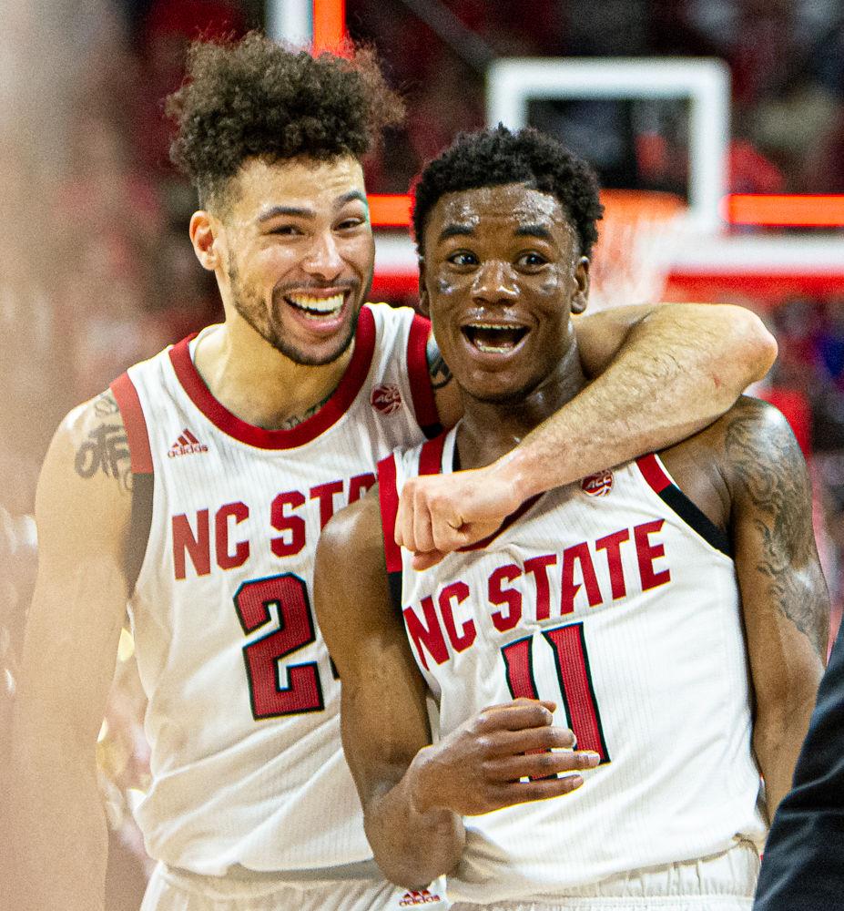 Redshirt junior guard Devon Daniels and senior guard Markell Johnson exit the court after Johnson&#8217;s half-court buzzer-beater to end the first half against Duke on Wednesday, Feb. 19 at PNC Arena. Daniels and Johnson combined for 53 points as the Wolfpack upset No. 6 Duke 88-66.