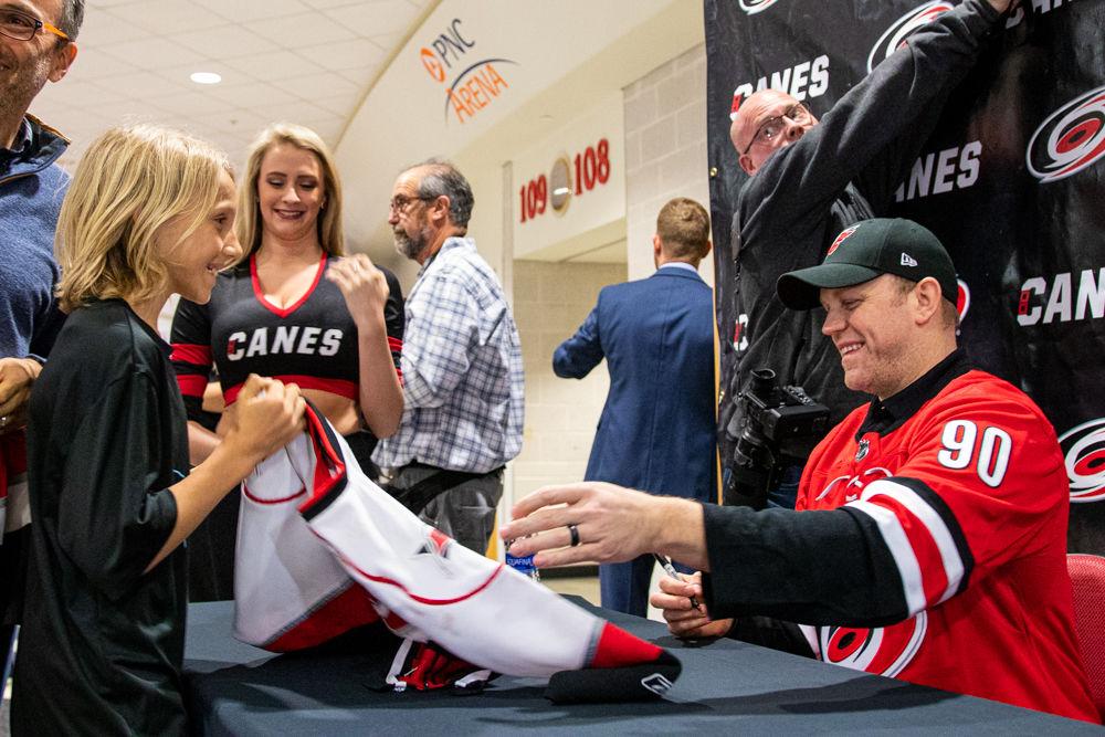 David Ayres signs a shirt for a fan on Tuesday, Feb. 25, 2020 at PNC Arena. Ayres served as the emergency back up goalie for the Canes on Feb. 22 versus the Maple Leafs as both Peter Mrazek and James Reimer were injured during the game the Carolina Hurricanes won 6-3.