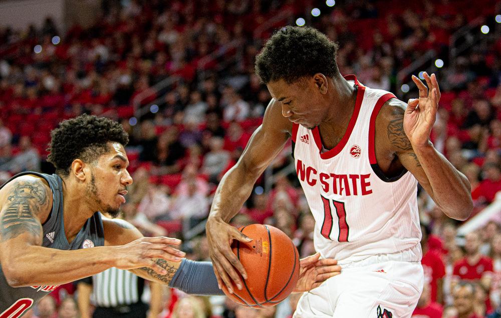 Senior guard Markell Johnson vies for a loose ball against Louisville on Saturday, Feb. 1, 2020 at PNC Arena. Johnson recorded eight points, five assists and five rebounds as the Wolfpack lost 77-57.