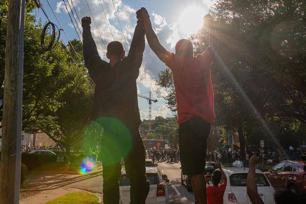 Protesters stand atop their car during the protest for the death of George Floyd on Saturday, May 30, 2020 in downtown Raleigh. The protest was one among many around the United States in response to the death of George Floyd in Minneapolis.