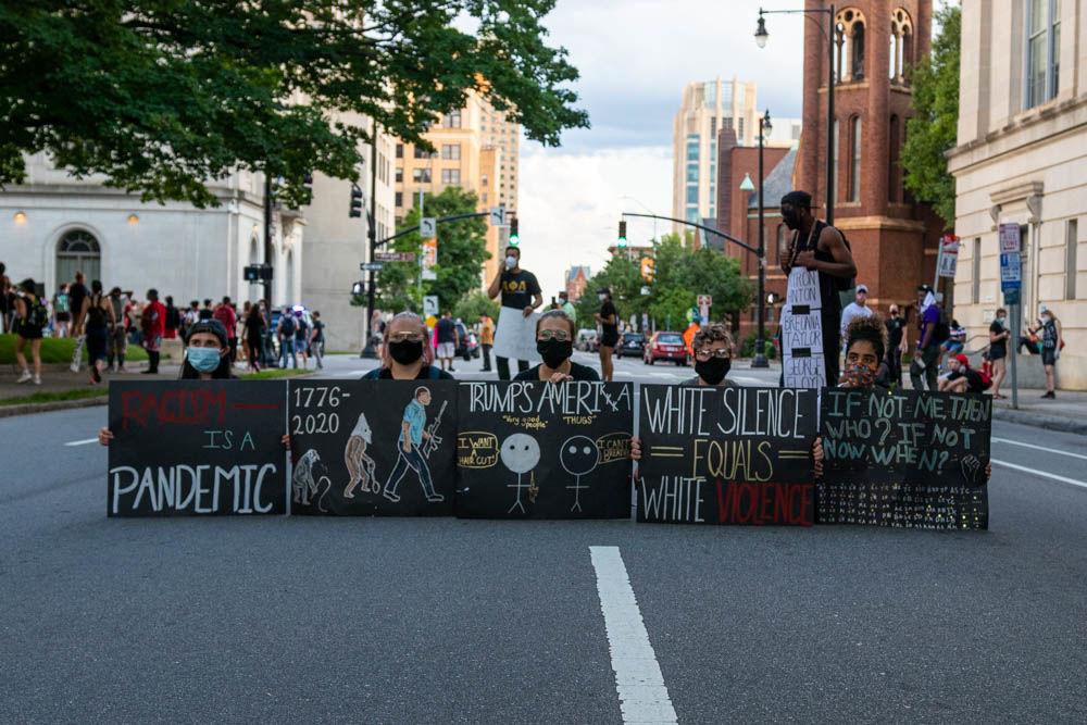Protesters sit on the street during a demonstration on Saturday, May 30, 2020 in downtown Raleigh. The protest was one among many around the United States in response to the death of George Floyd in Minneapolis.