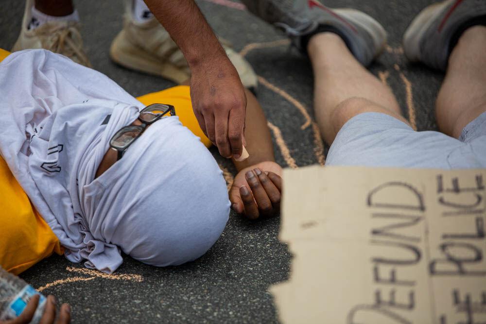 Protesters use chalk to outline themselves during a die-in protest in front of the capitol on Tuesday, June 2, 2020 in Downtown Raleigh. The protesters marched from the Duke Energy Center, to the governors mansions and then back. This was the second night of peaceful protests Raleigh.