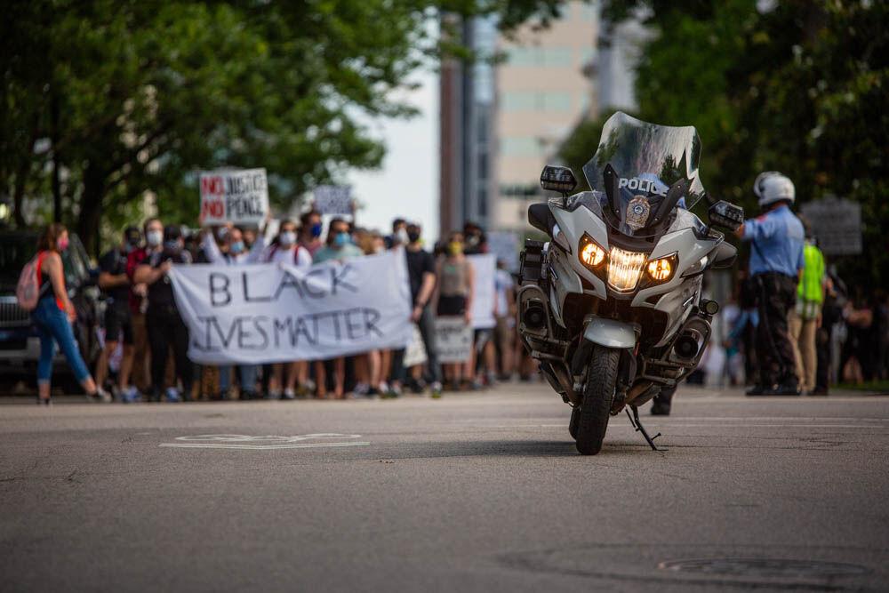 A police vehicle is parked ahead of the protesters in front of an intersection on Tuesday, June. 2, 2020 in Downtown Raleigh. Police assisted in proceeding through the streets unhindered.