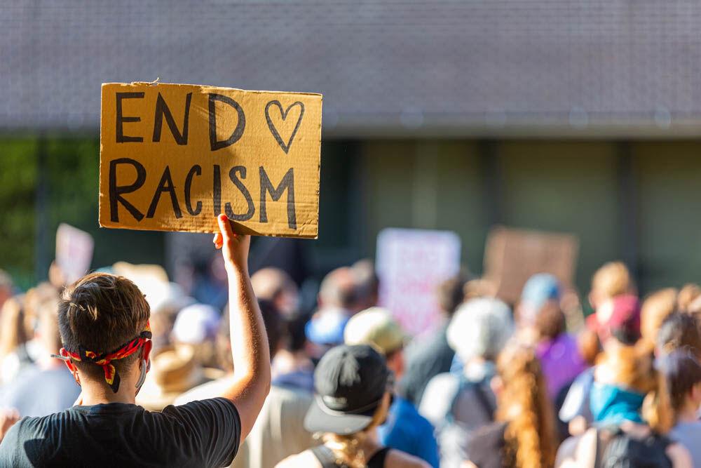 A protester holds up a sign outside the City of Raleigh Municipal Building on Thursday, June 4, 2020 in Downtown Raleigh.